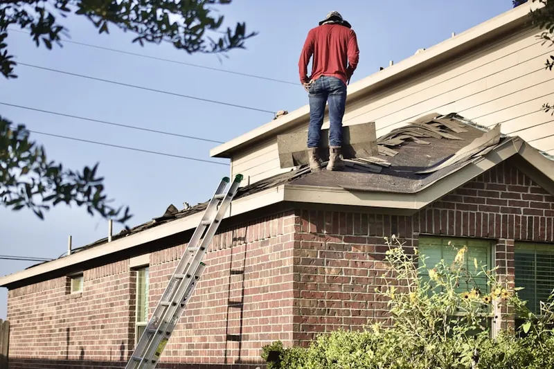 Professional roofer working on a residential roof in Anthem Park